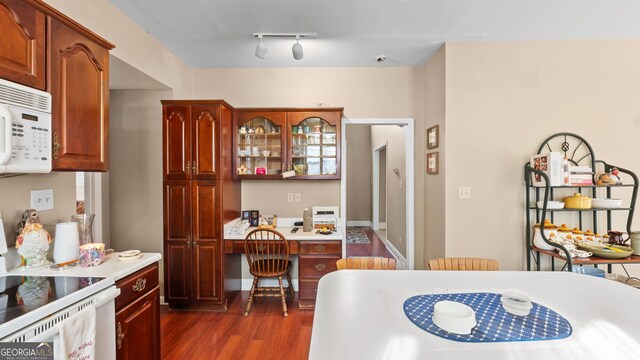 26 The Trl SE, Lindale, GA 30147 - kitchen with white appliances, dark wood-type flooring, light countertops, glass insert cabinets, and track lighting