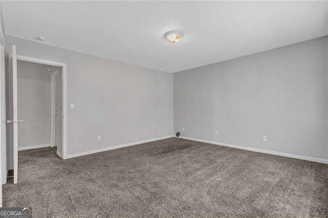 empty room with carpet flooring and baseboards