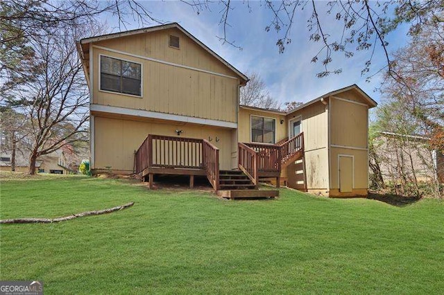 2895 Wildflower Ln, Snellville, GA 30039 - back of property with a wooden deck, a yard, and stairway