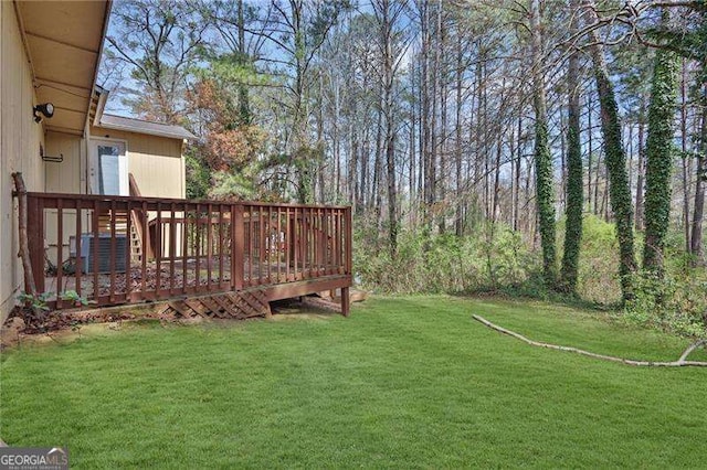 2895 Wildflower Ln, Snellville, GA 30039 - view of green lawn with a deck