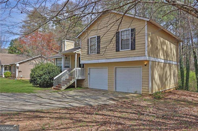 2895 Wildflower Ln, Snellville, GA 30039 - split level home with an attached garage and driveway