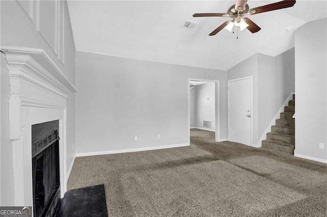 2895 Wildflower Ln, Snellville, GA 30039 - unfurnished living room with ceiling fan, carpet flooring, lofted ceiling, stairs, and a fireplace