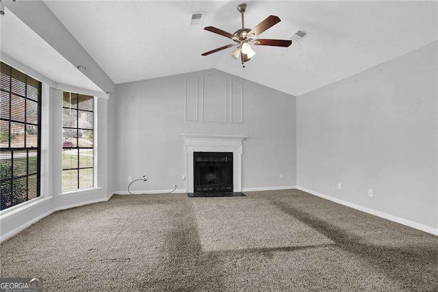 2895 Wildflower Ln, Snellville, GA 30039 - unfurnished living room with vaulted ceiling, ceiling fan, carpet flooring, and a fireplace with flush hearth
