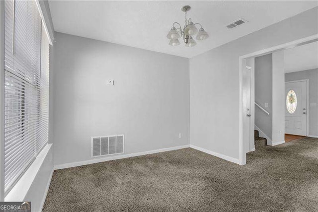 2895 Wildflower Ln, Snellville, GA 30039 - unfurnished room with a chandelier, carpet, and stairway
