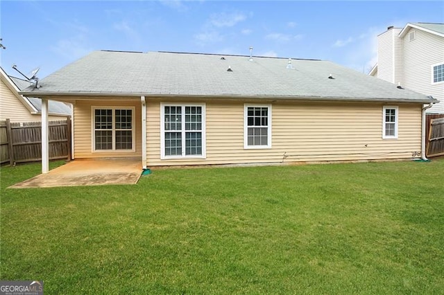 rear view of house featuring a yard, fence, and a patio area