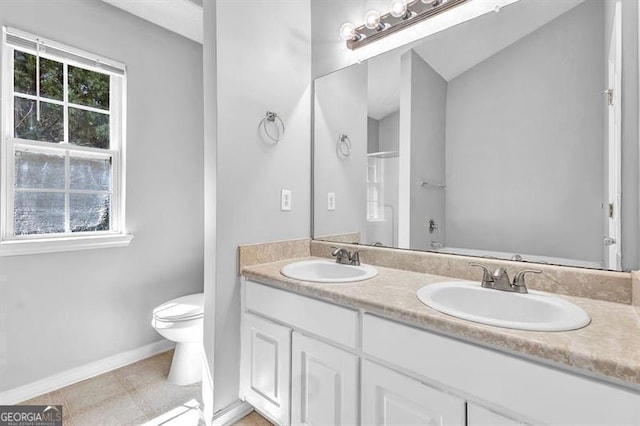 bathroom with a wealth of natural light, a sink, and toilet