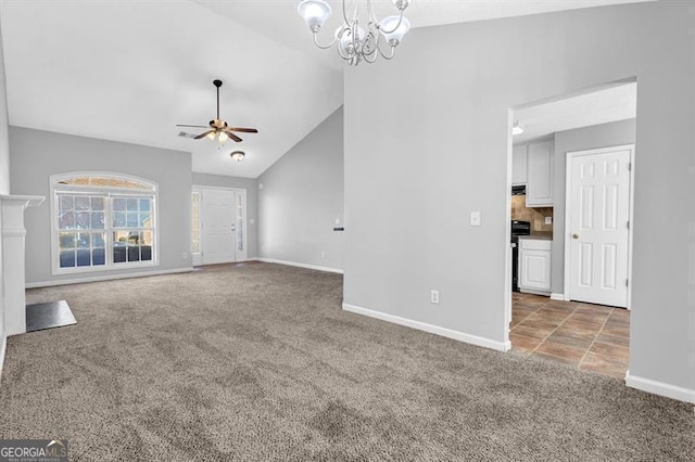 unfurnished living room featuring baseboards, high vaulted ceiling, carpet, and ceiling fan with notable chandelier