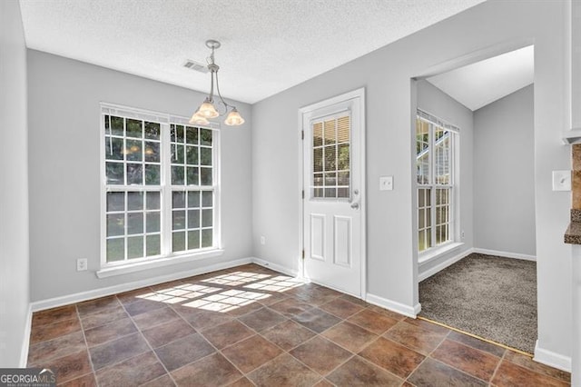 foyer with visible vents, baseboards, a chandelier, and a textured ceiling