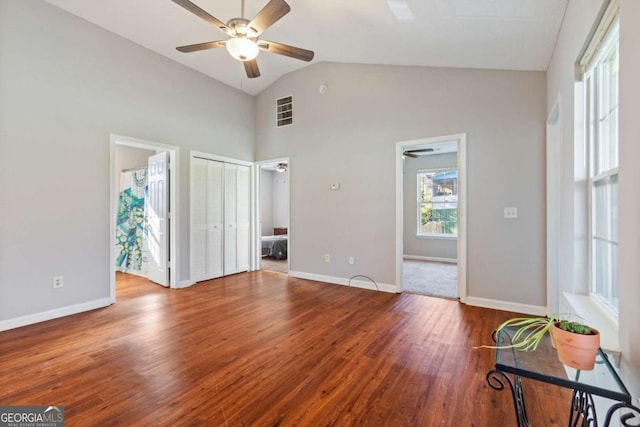 32 Martin Luther King Jr Dr, Commerce, GA 30529 - unfurnished living room with visible vents, wood finished floors, baseboards, high vaulted ceiling, and a ceiling fan