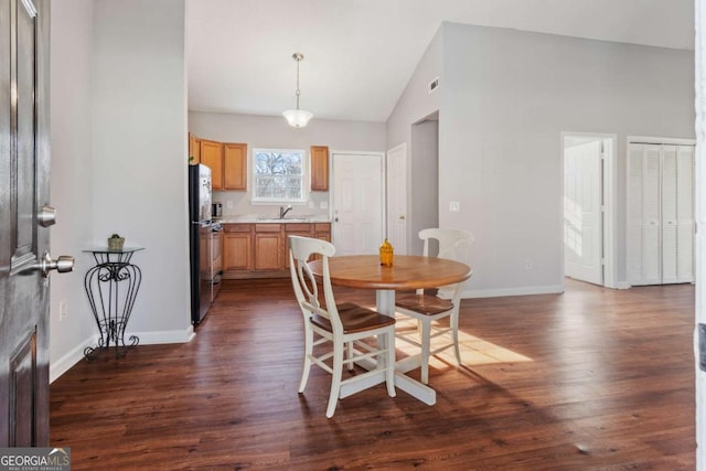 32 Martin Luther King Jr Dr, Commerce, GA 30529 - dining area featuring visible vents, baseboards, dark wood finished floors, and high vaulted ceiling