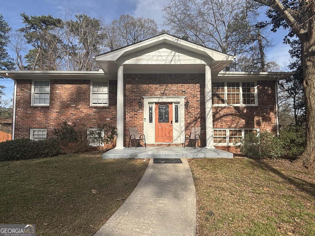 2784 Williamsburg Way, Decatur, GA 30034 - view of front facade with a front lawn, covered porch, and brick siding