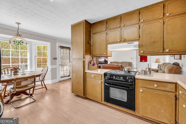 kitchen with light countertops, light wood-style floors, under cabinet range hood, and electric range oven