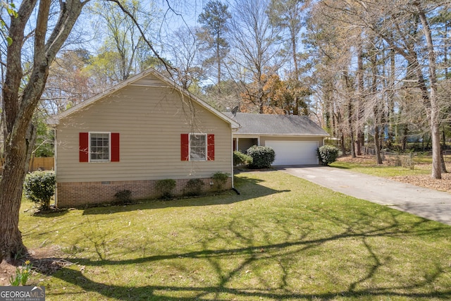 view of side of property featuring crawl space, driveway, an attached garage, and a yard