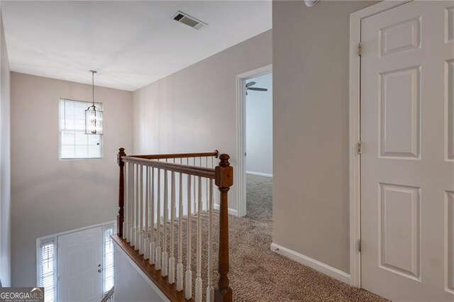 5027 Lower Elm St, Atlanta, GA 30349 - hall with carpet flooring, an upstairs landing, and a chandelier