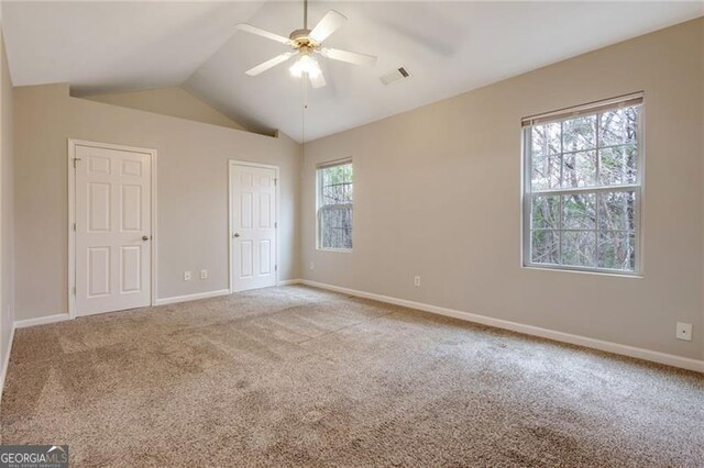 5027 Lower Elm St, Atlanta, GA 30349 - unfurnished bedroom featuring carpet floors, lofted ceiling, and a ceiling fan