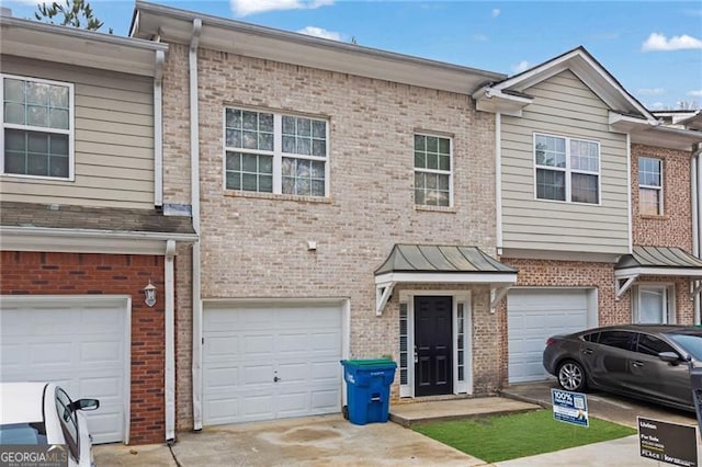 5027 Lower Elm St, Atlanta, GA 30349 - multi unit property with brick siding, a garage, and driveway