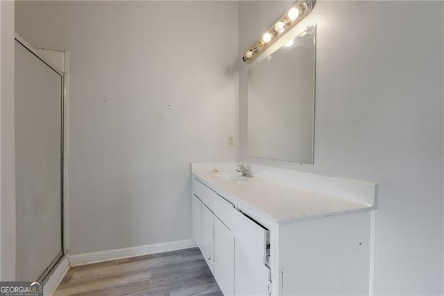 864 Oakhill Ct, Stone Mountain, GA 30088 - bathroom with vanity, wood finished floors, and a shower