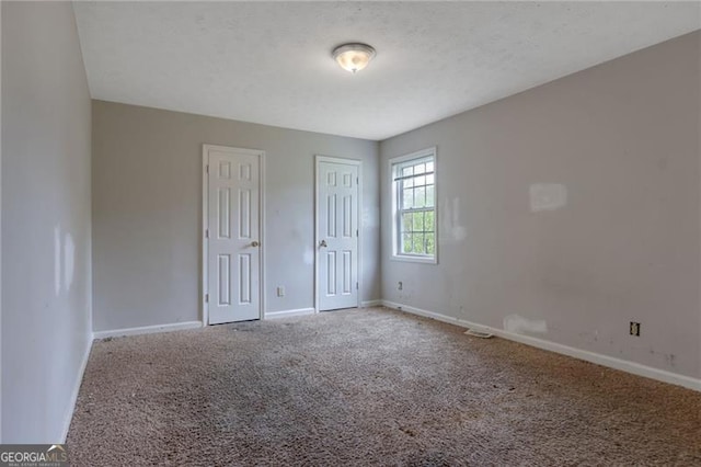 864 Oakhill Ct, Stone Mountain, GA 30088 - unfurnished bedroom featuring carpet floors and two closets