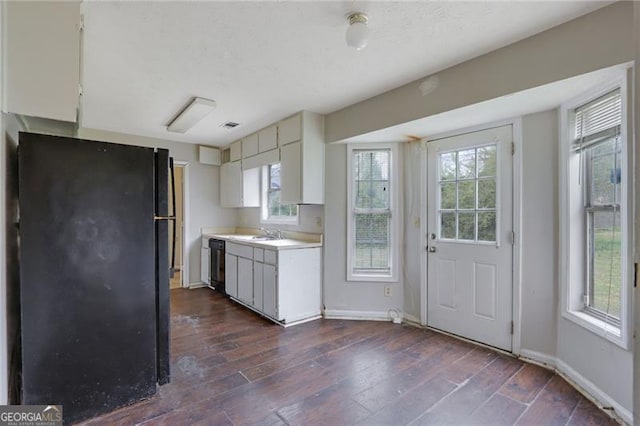 864 Oakhill Ct, Stone Mountain, GA 30088 - kitchen with black appliances, light countertops, plenty of natural light, and dark wood-type flooring