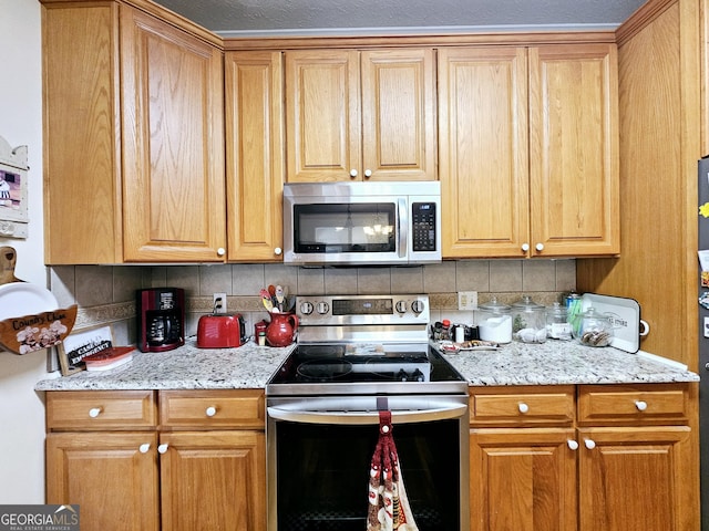 403 Holiday Rd, Franklin, GA 30217 - kitchen featuring tasteful backsplash, appliances with stainless steel finishes, and light stone counters