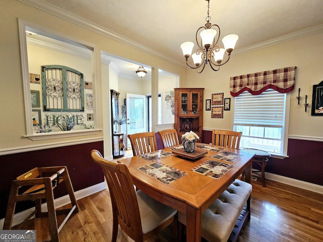 403 Holiday Rd, Franklin, GA 30217 - dining area featuring a chandelier, baseboards, wood finished floors, and crown molding