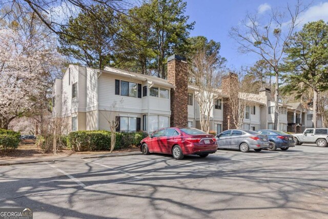 view of property with a residential view and uncovered parking