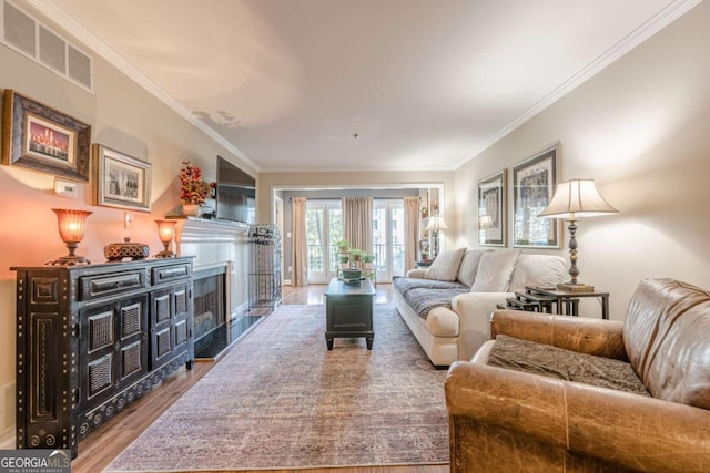 3201 Lenox Rd NE Unit 16, Atlanta, GA 30324 - living room featuring wood finished floors, crown molding, and a fireplace