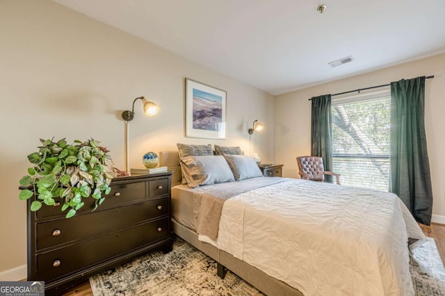 bedroom featuring baseboards and wood finished floors