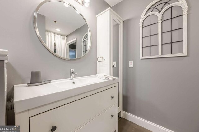 bedroom featuring baseboards, visible vents, and wood finished floors