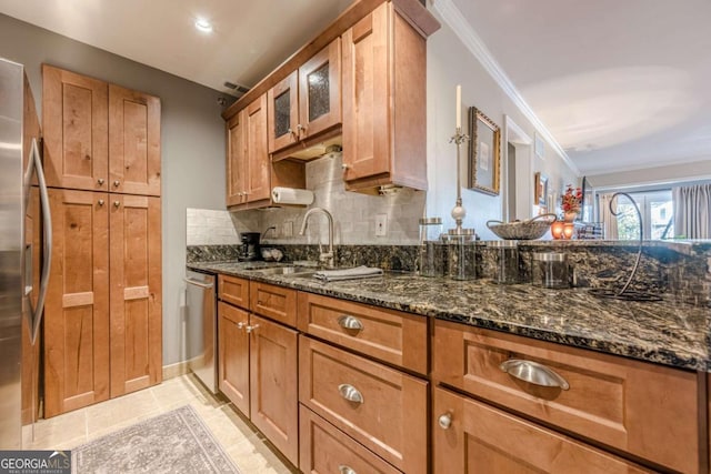 3201 Lenox Rd NE Unit 16, Atlanta, GA 30324 - kitchen featuring appliances with stainless steel finishes, ornamental molding, backsplash, brown cabinetry, and dark stone countertops