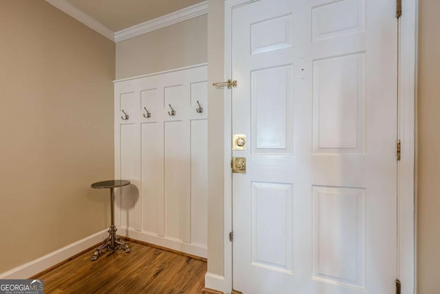 kitchen with dark stone counters, ornamental molding, stainless steel appliances, and light wood-type flooring