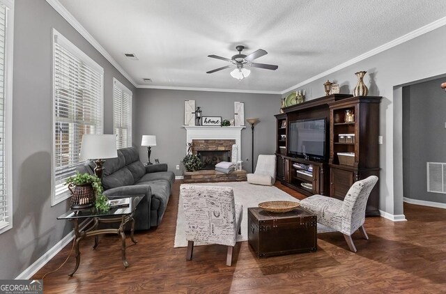 310 Persimmon Dr, Sharpsburg, GA 30277 - living room featuring a ceiling fan, wood finished floors, a fireplace, and crown molding