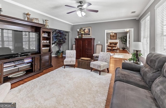310 Persimmon Dr, Sharpsburg, GA 30277 - living area featuring wood finished floors, ceiling fan, ornamental molding, and a chandelier