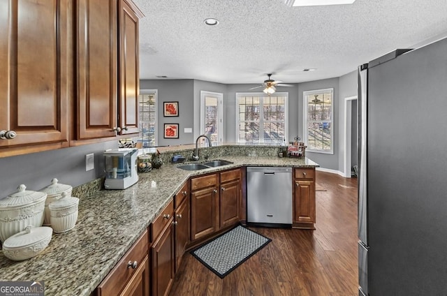 310 Persimmon Dr, Sharpsburg, GA 30277 - kitchen featuring appliances with stainless steel finishes, a textured ceiling, dark wood-style floors, a peninsula, and a ceiling fan