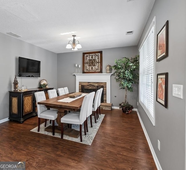 310 Persimmon Dr, Sharpsburg, GA 30277 - dining space with wood finished floors, a chandelier, and a stone fireplace