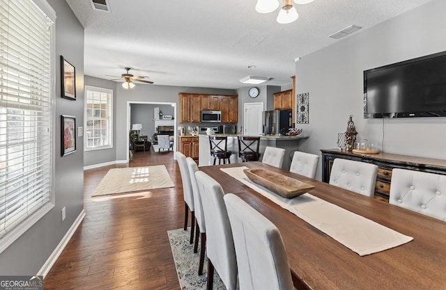 310 Persimmon Dr, Sharpsburg, GA 30277 - dining room featuring ceiling fan and dark wood-type flooring