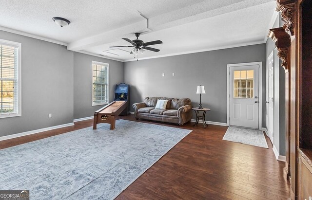 310 Persimmon Dr, Sharpsburg, GA 30277 - living area with dark wood finished floors, ceiling fan, crown molding, and a textured ceiling