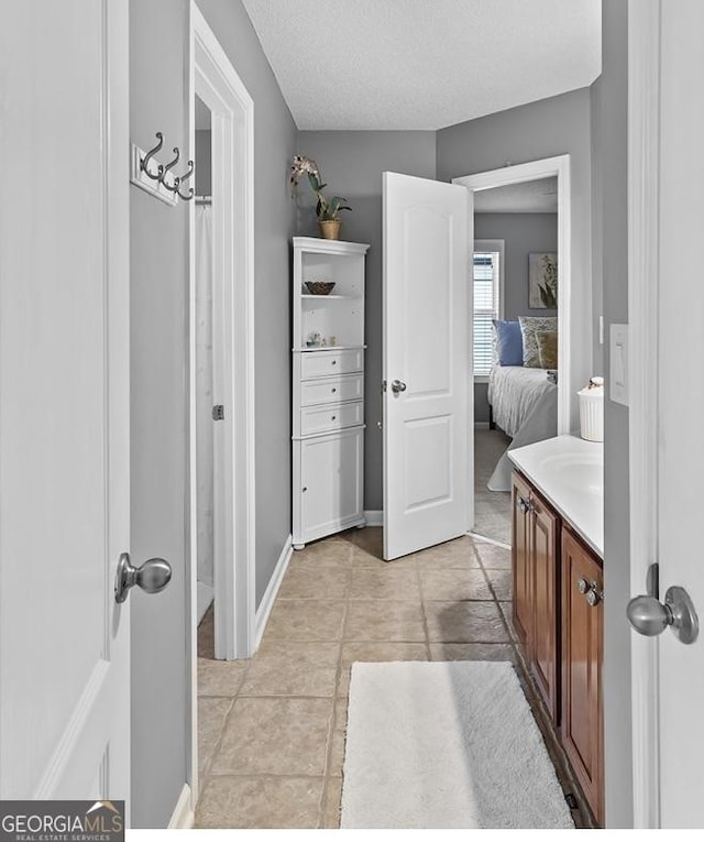 310 Persimmon Dr, Sharpsburg, GA 30277 - ensuite bathroom featuring vanity, tile patterned floors, and a textured ceiling