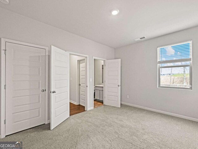 2027 Massey Ln, Winder, GA 30680 - unfurnished bedroom with ensuite bath, carpet flooring, visible vents, and baseboards