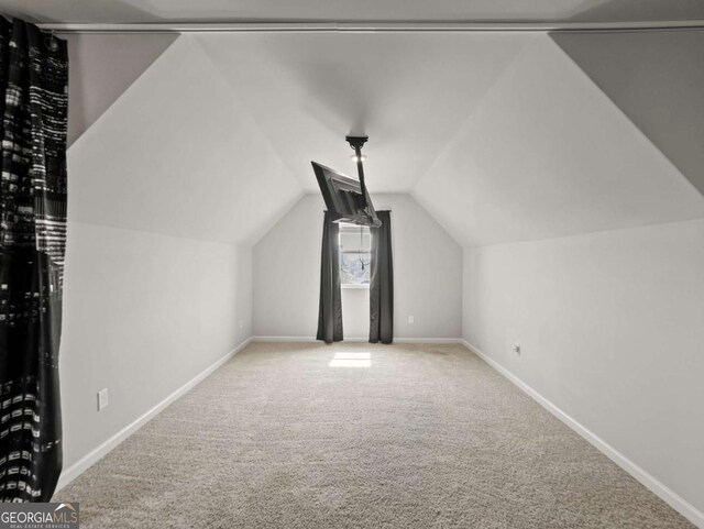 2027 Massey Ln, Winder, GA 30680 - bonus room featuring lofted ceiling, carpet flooring, and baseboards