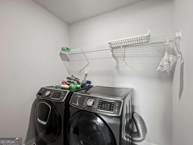 2027 Massey Ln, Winder, GA 30680 - laundry room featuring washer and dryer, baseboards, and laundry area