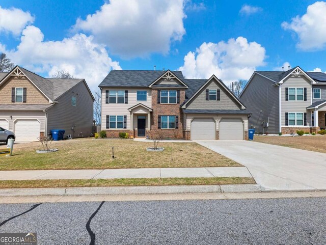 2027 Massey Ln, Winder, GA 30680 - view of front facade with a garage, driveway, brick siding, and a front yard