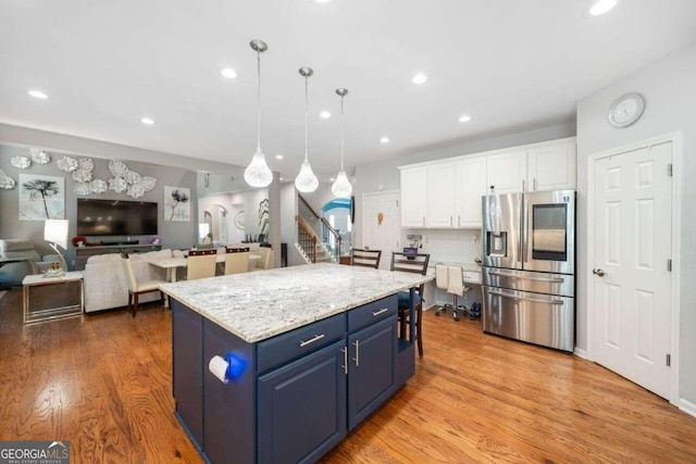 3015 Gold Creek Dr, Villa Rica, GA 30180 - kitchen featuring stainless steel refrigerator with ice dispenser, blue cabinetry, white cabinetry, light wood-type flooring, and recessed lighting
