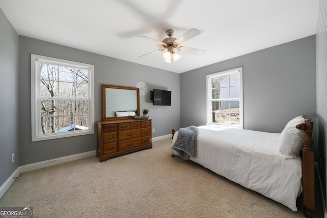 carpeted bedroom with baseboards and a ceiling fan