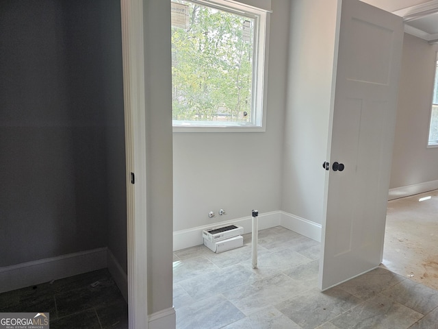 6841 Phillips Mill Rd, Douglasville, GA 30135 - laundry area with healthy amount of natural light, baseboards, and stone finish floors