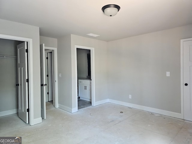 6841 Phillips Mill Rd, Douglasville, GA 30135 - unfurnished bedroom with baseboards, a closet, ensuite bath, and a spacious closet