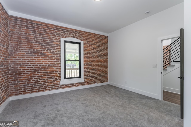 6592 Factory Shoals Rd SW, Mableton, GA 30126 - empty room with brick wall, carpet flooring, baseboards, stairs, and a smoke detector