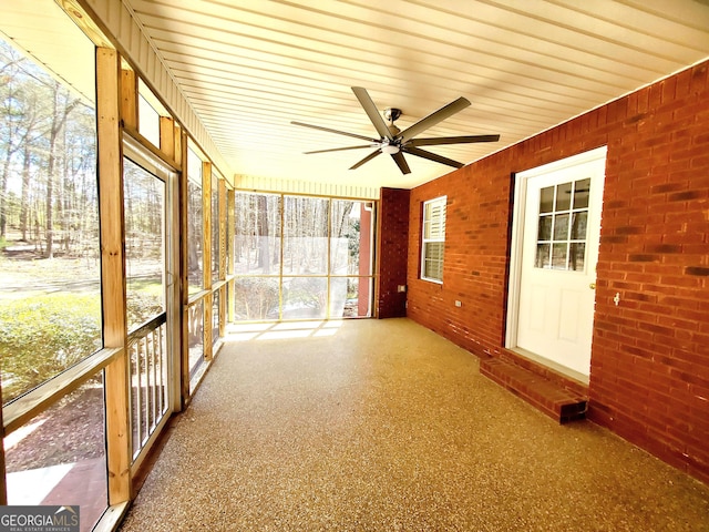 unfurnished sunroom with a ceiling fan