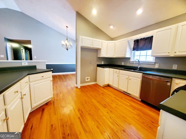 kitchen featuring stainless steel dishwasher, dark countertops, a sink, light wood-type flooring, and lofted ceiling