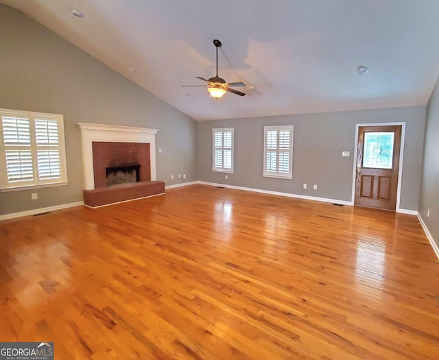 unfurnished living room with vaulted ceiling, baseboards, visible vents, light wood-style floors, and a ceiling fan